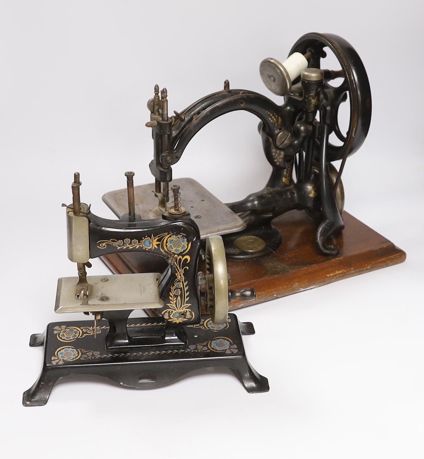A Victorian Wilcox ad Gibbs sewing machine and a smaller sewing machine, 28cm high